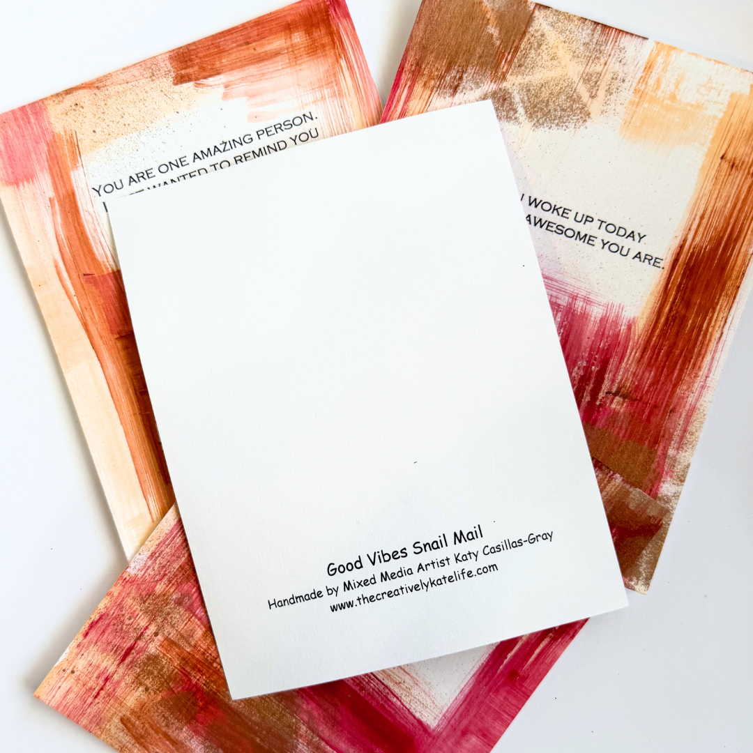 Good Vibes Snail Mail “The Amazing Pack” featuring four handpainted encouragement cards with uplifting quotes, wrapped with a glitter band and heart sticker, designed to brighten mailboxes and send meaningful handwritten connection.