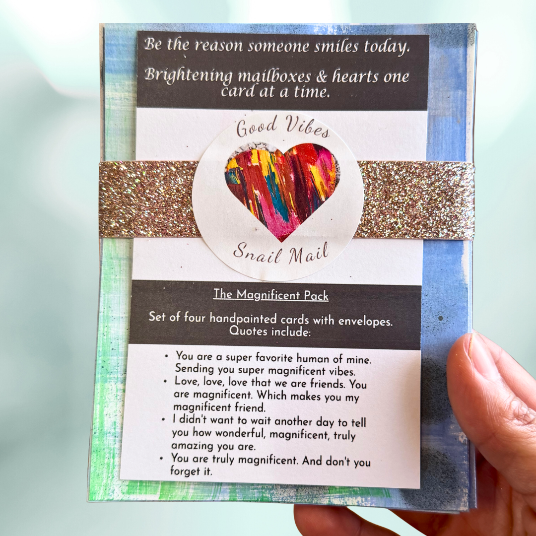 Good Vibes Snail Mail “The Magnificent Pack” featuring four handpainted encouragement cards with uplifting quotes, wrapped with a glitter band and heart sticker, created to brighten mailboxes and foster meaningful handwritten connection.