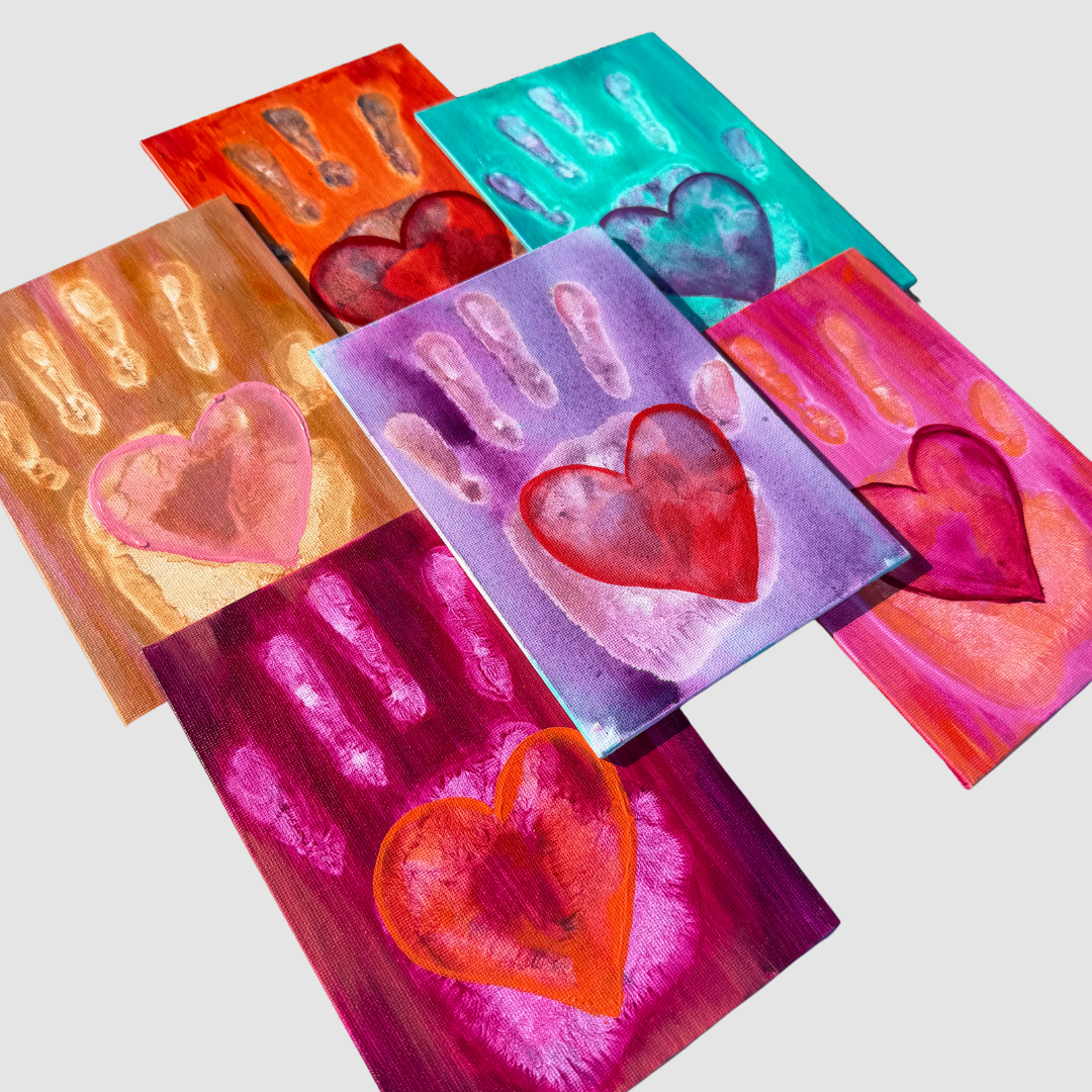 Original 5x7 hand-painted acrylic heart art featuring colorful handprints on a pink canvas board, a unique handmade friendship gift from Good Vibes Snail Mail.