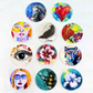 colorful assorted 2.5" circular stickers featuring artwork of animals, florals, and figures.