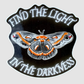 Inspirational 2.5-inch die-cut moth sticker featuring a gray and orange Cecropia moth on a black background with the words Find the Light in the Darkness.